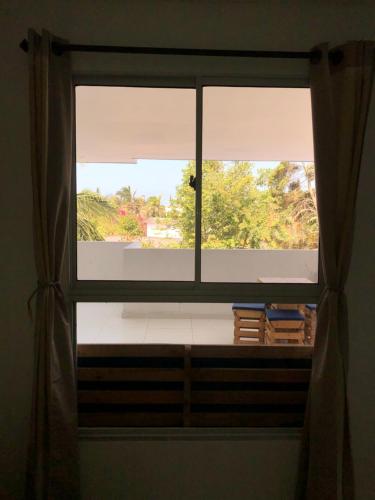 a window with a view of a room at HOTEL ARRECIFE in Santa Veronica