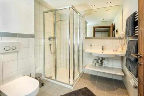 a bathroom with a shower and a toilet and a sink at Sunup Appartements Sölden in Sölden