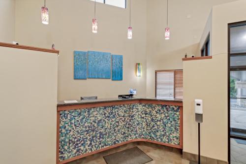 a lobby with a tile counter with blue paintings at Waterbird Lakeside Inn in Chesterton