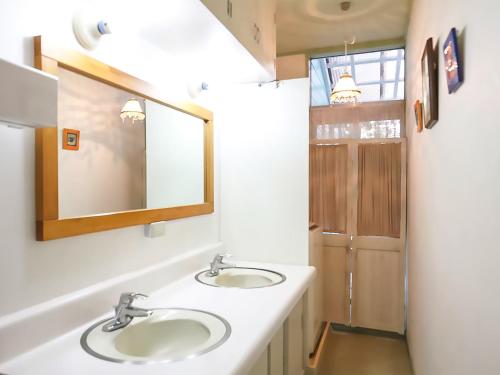 a bathroom with two sinks and a mirror at Human resort in Yamanakako