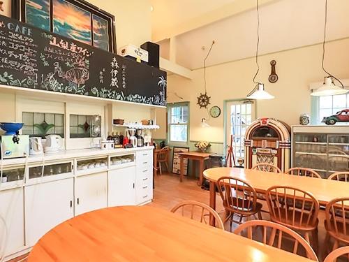 a kitchen and dining room with tables and chairs at Human resort in Yamanakako