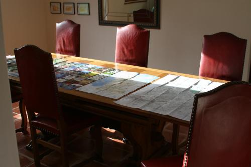 a table with chairs around it with a quilt on it at The Magnolias B&B in Moyon
