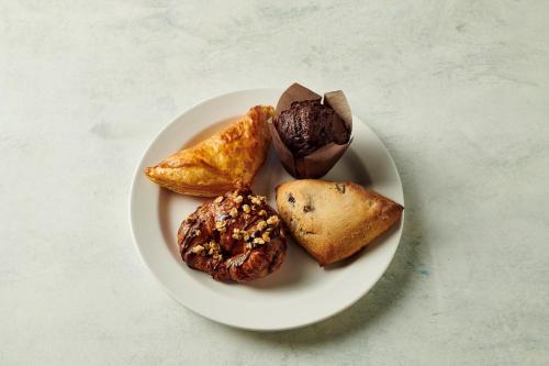 a plate of pastries and muffins on a table at Holiday Inn Ardmore by IHG in Ardmore