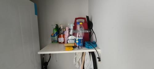 a shelf with many different cleaning products on it at Pedacito de cielo in Progreso