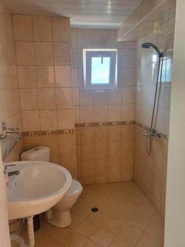 a bathroom with a tub and a toilet and a sink at Guest House Plamena in Krapets