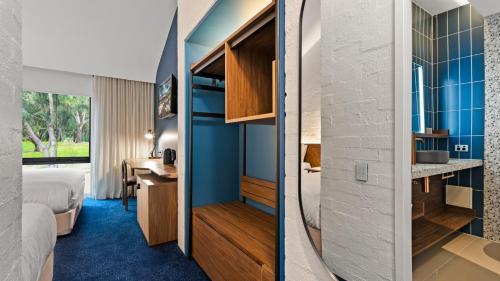 a hotel room with a bed and a bathroom at Eden Oak Geelong in Geelong