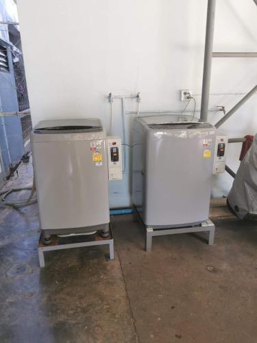 two machines are sitting in a room at Thanya Mansion in Kanchanaburi City
