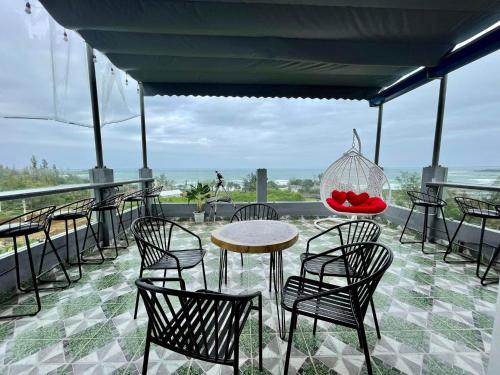 a table and chairs with a bowl of fruit on a patio at Chiến Cảnh Hotel in An Châu