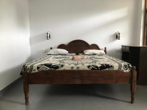 a bedroom with a bed with a blanket on it at Freedom Beach Arugam Bay in Arugam Bay