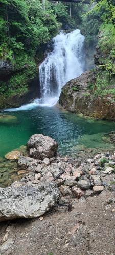 a waterfall in the middle of a river at Alice Chalet Bled - Adults only in Bled