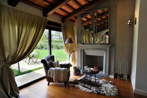 a living room with a chair and a fireplace at San Giovanni Relais in San Giovanni in Marignano
