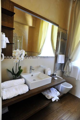 a bathroom with a sink and a mirror at San Giovanni Relais in San Giovanni in Marignano
