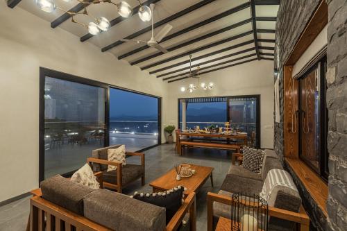 a living room with a view of the ocean at SaffronStays Ahilya Waters by Kosha Villas, Pawna - pool villa with panoramic view of Pawna Lake in Āmbavna