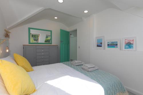 a bedroom with a large bed with towels on it at Hillywych Studio in Redruth