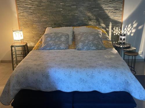 a bed with a blue comforter and pillows on it at Metris 5 in Corre