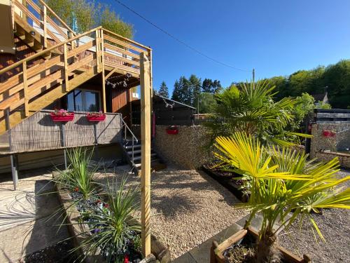 a house with a wooden staircase and potted plants at Gîte du Silo Loft atypique ,Tournesol , spa&piscine couverte in Toucy