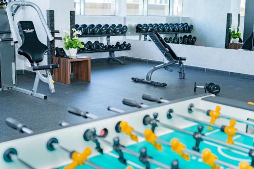a room with a gym with a bunch of swissisers at Luxe Grand Hotel Apartments in Sharjah
