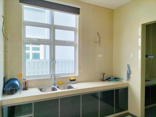 a kitchen with a sink and a window at My Home Kayangan Villa Malacca C10 in Melaka