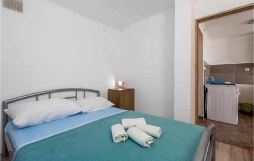 a bedroom with a bed with towels on it at Amazing Apartment In Stinica With Kitchen in Stinica