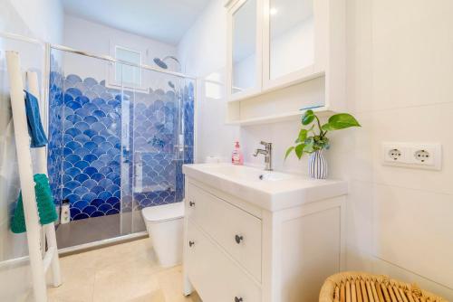 a white bathroom with a sink and a shower at Can Torres in Pòrtol