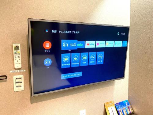 a flat screen tv hanging on a wall at Hotel Prezier Akihabara - Vacation STAY 21812v in Tokyo