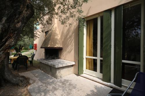 a stone fireplace in the side of a house at Appartamenti Pratone in Garda