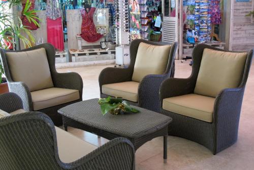 a group of chairs and a table in a store at Hotel Fleur d'Epee in Le Gosier