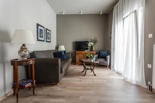 a living room with a couch and a tv at The Beetle House in Volos