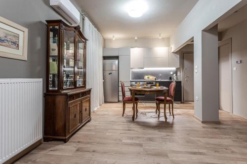 a kitchen and dining room with a table and chairs at The Beetle House in Volos