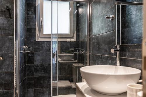 a bathroom with a sink and a toilet and a shower at The Beetle House in Volos