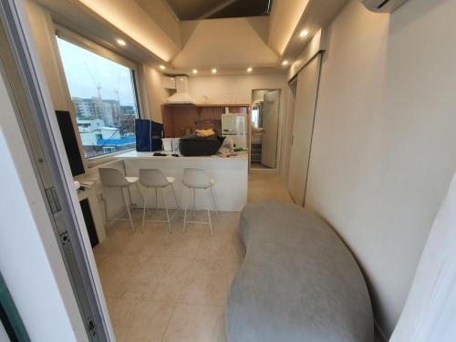 a living room with a couch and a kitchen at Mr. Slow in Sokcho