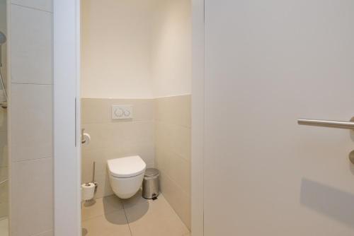 a bathroom with a white toilet in a room at Vienna Stay Apartments Linzerstrasse in Vienna