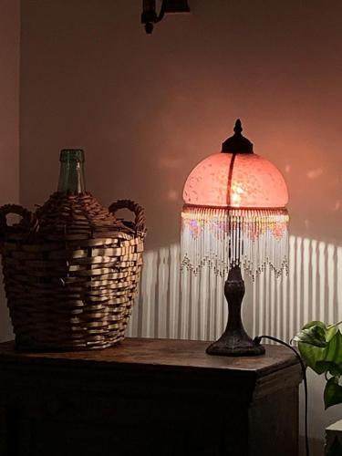 a lamp sitting on a table next to a basket at Elendar Morpeth Circa 1890 in Morpeth
