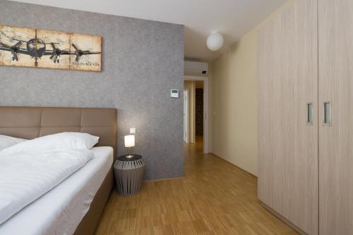 a bedroom with a bed and a painting on the wall at Vienna Stay Apartments Linzerstrasse in Vienna