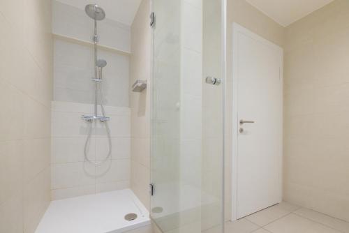 a shower with a glass door in a bathroom at Vienna Stay Apartments Linzerstrasse in Vienna
