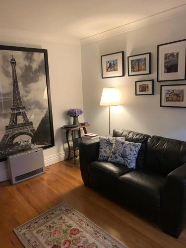 a living room with a couch and a picture of the eiffel tower at Elendar Morpeth Circa 1890 in Morpeth
