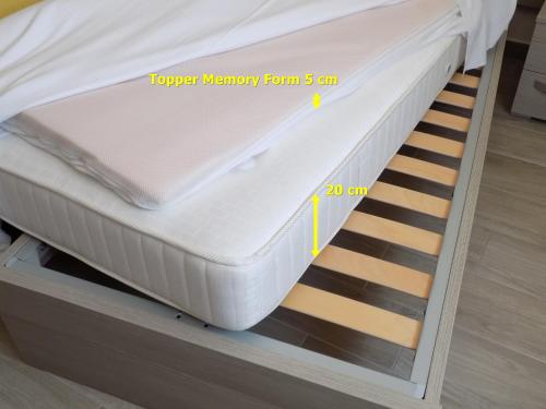 a mattress is stacked on top of a bed at MillyHolidays - Apartment Lillà - Center - Nearby Beach - Private Garden - Spa Pool in Bardolino