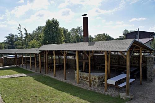 a pavilion with wooden posts and a roof at Hotel Biele Studničky Dargov in Dargov