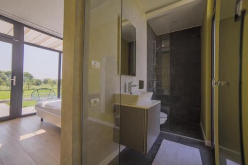 a bathroom with a sink and a toilet and a shower at Bungalows Kingsland in Ineu