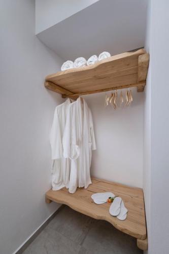 a bathroom with a wooden shelf with towels at Palios Stathmos in Miléai
