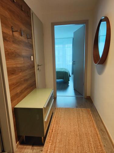 een kamer met een tafel, een spiegel en een deur bij Beachfront Paradise Ezüst Panoráma lakeview apartment with panoramic terrace in Siófok