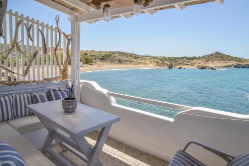 a balcony with a table and a view of the ocean at Fisherman's Syrma House in Pachaina