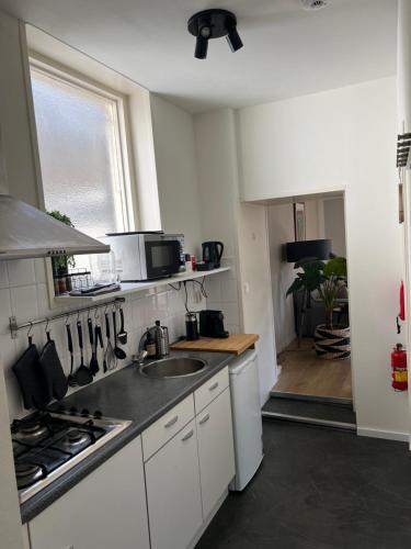 a kitchen with a sink and a stove at Kalckmate in Goes