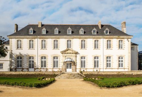 a large white building with a black roof at Abbaye De Villeneuve in Les Sorinières