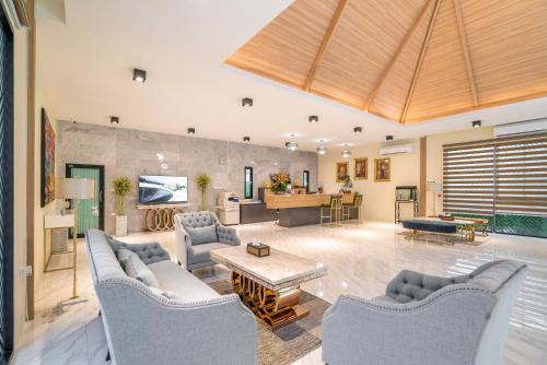 a large living room with couches and a table at Rawayana West Villas & Kids Park in Rawai Beach