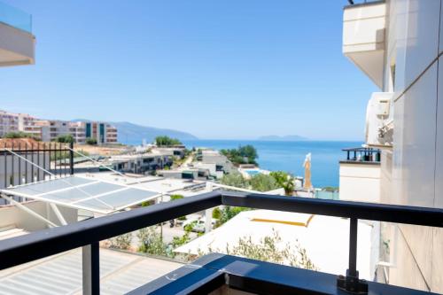 ヴロラにあるBay Inn Apartment Sea Frontのテニスコート付きの建物のバルコニーから景色を望めます。