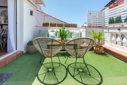 un par de sillas de bicicleta sentadas en un balcón en Fantastic Penthouse Malaga Center, en Málaga