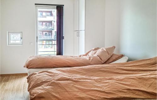 1 dormitorio con cama y ventana en Nice Apartment In Kristiansand With Wifi And 2 Bedrooms en Kristiansand