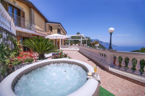 a hot tub on the balcony of a building at Villa Costanza sorrento B&b in Sant'Agnello