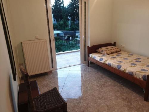 a bedroom with a bed and a sliding glass door at Luxury seaside apartment, 3 bedrooms in Livanates